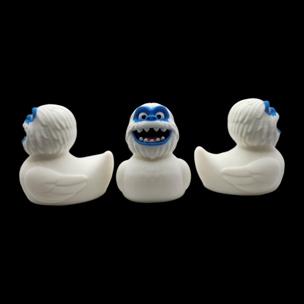 White 3D printed Yeti duck shown from the front and sides, highlighting its rounded body and raised tail.- JM Designs