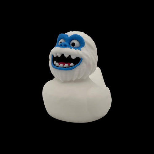 Three white 3D printed Yeti ducks with blue faces and wide smiles, shown facing forward.