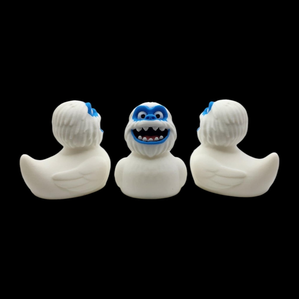 Front and rear views of a white 3D printed Yeti duck, with the blue-faced front view in the center. - JM Designs