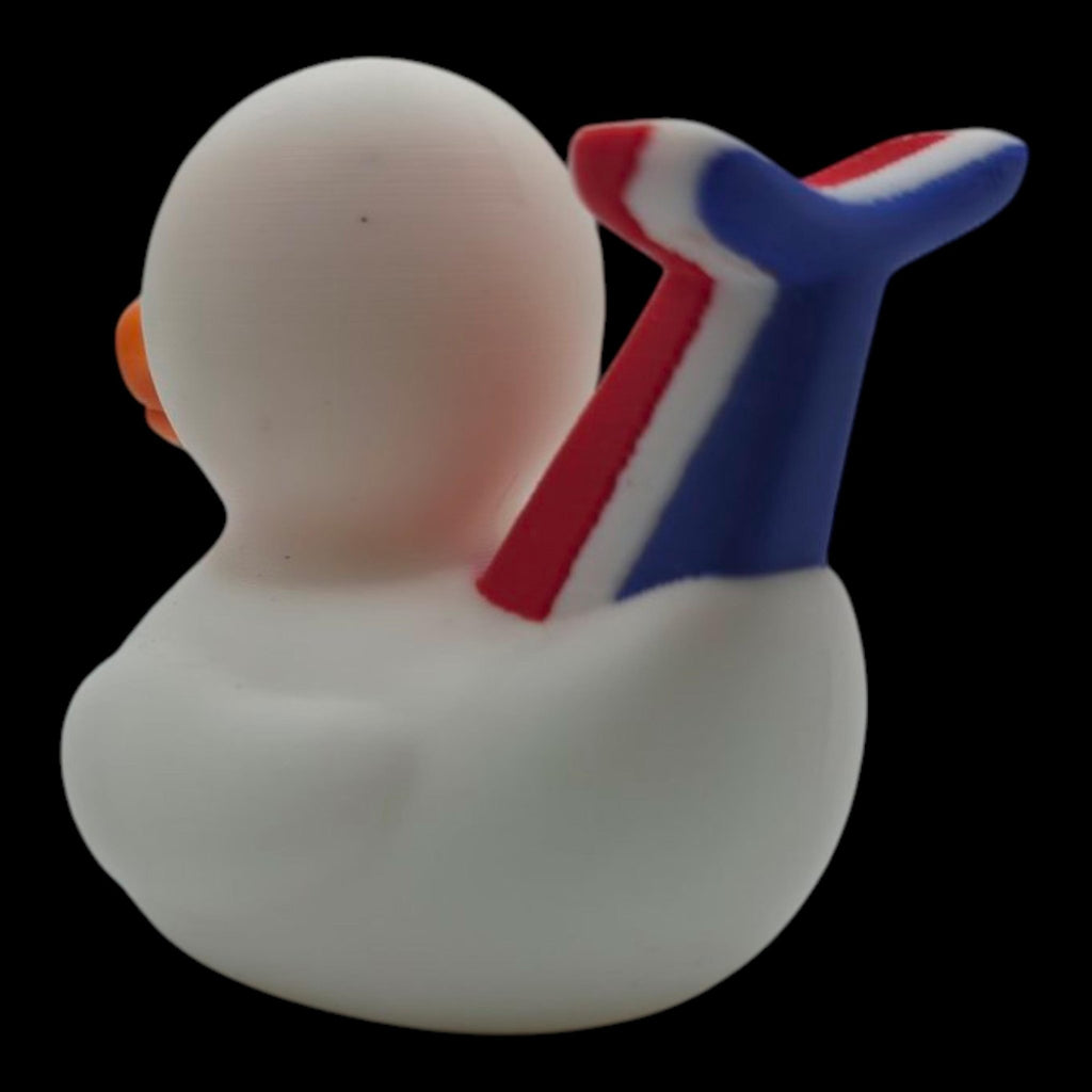 Left side view of a white 3D printed cruise duck showing its wing and red-and-blue whale-tail detail. - JM Designs
