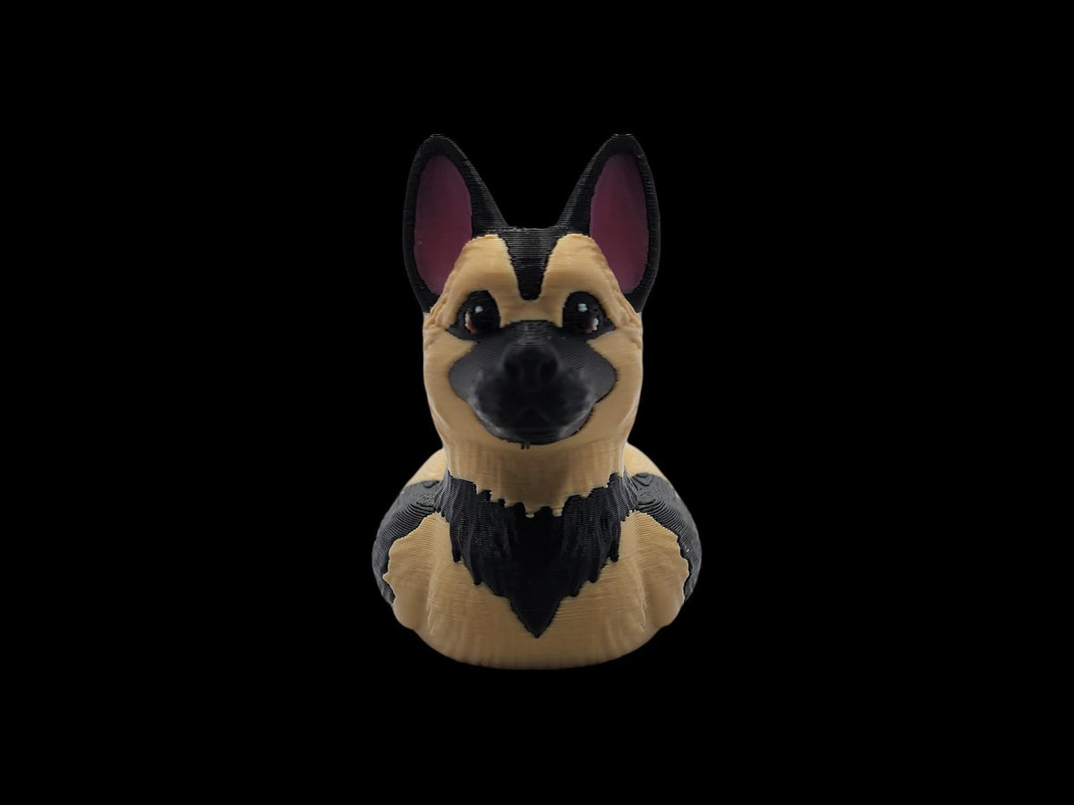 Black and tan 3D printed German Shepherd duck shown from the front on a black background.- JM Designs