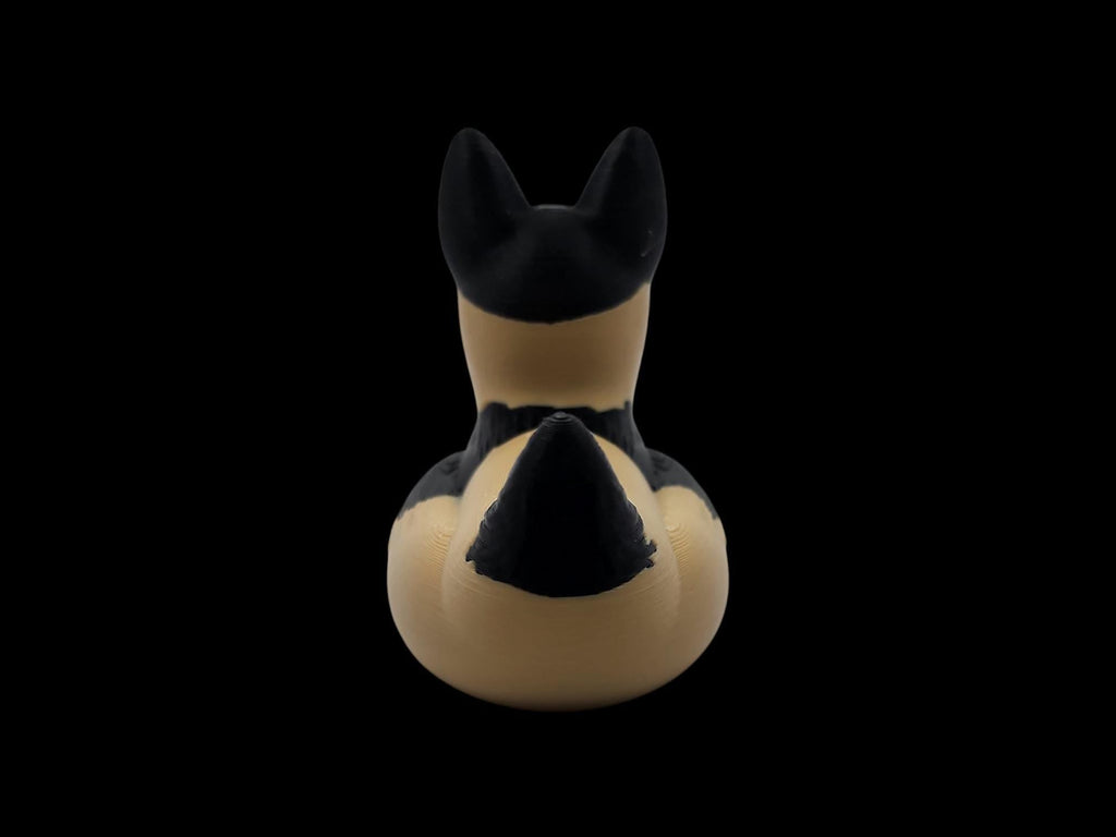 Rear view of a 3D printed German Shepherd duck showing black markings on its tan body. - JM Designs