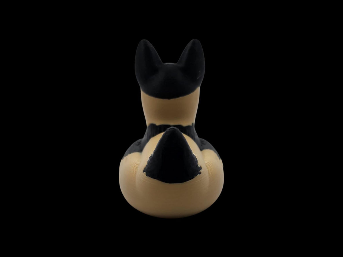 Rear view of a 3D printed German Shepherd duck showing black markings on its tan body. - JM Designs