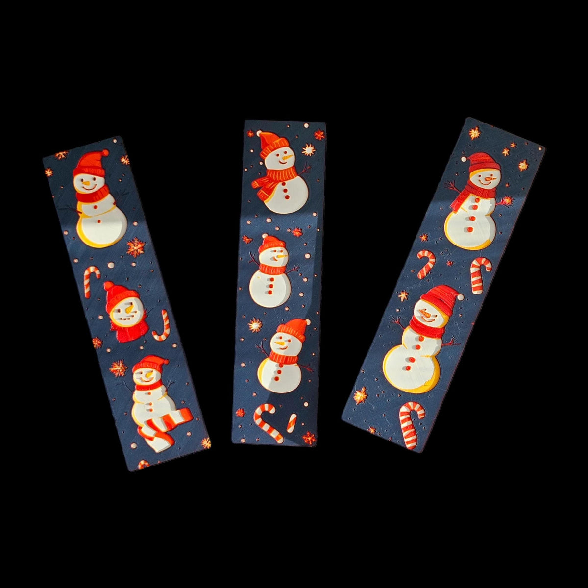 3D Printed Bookmark Christmas Snowman Design Winter Reading Accessory Holiday Gift Set Three Pack Book Lover Present Premium Filament Construction Dark Blue Background Festive Page Marker Red Hat Scarves Candy Canes Snowflakes Decoration